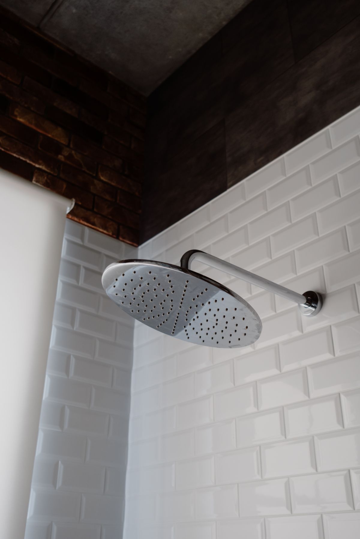 Chrome rainfall shower head on metro tiles